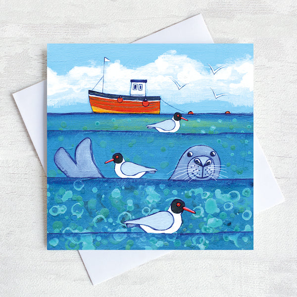 A charming greetings card from an original painting by Joanne Wishart, imaging floating on the water with these seal heads popping up above the surface to say hello!