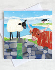 A friendship greetings card featuring a sheep and a highland cow chatting on an old stone wall. 