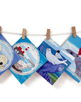 A washing line featuring a selection of greetings cards showcasing a selection of grey seal inspired designs by Joanne Wishart