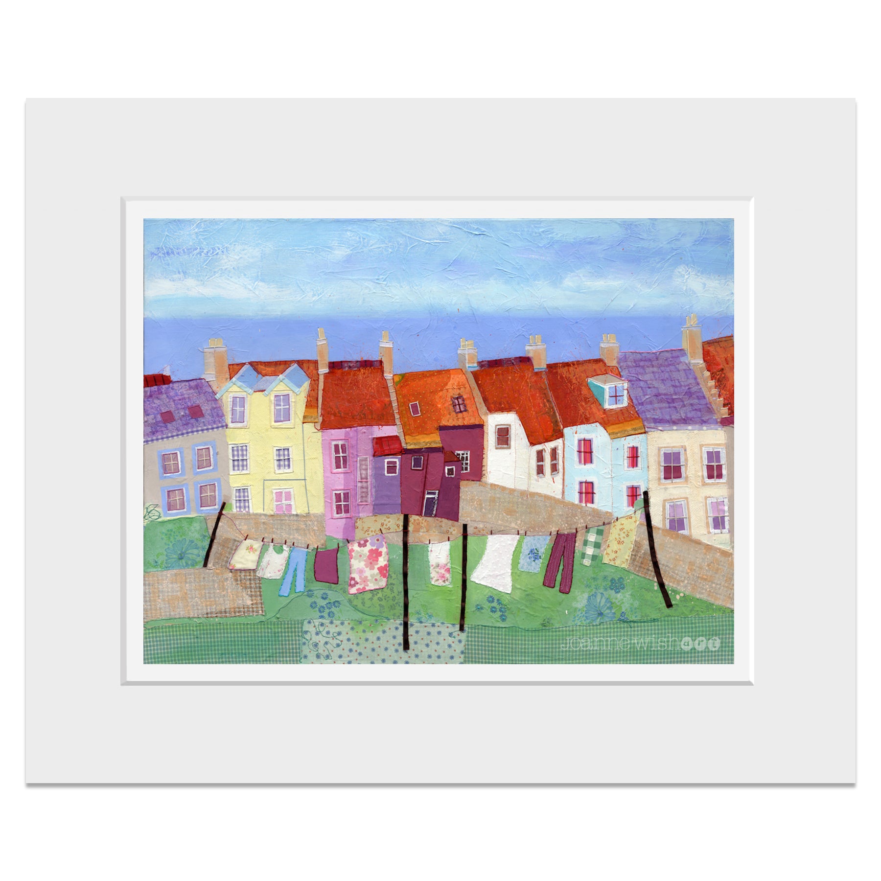 A mounted print of Pittenweem in Fife, with orange rooftops and waving on the line.