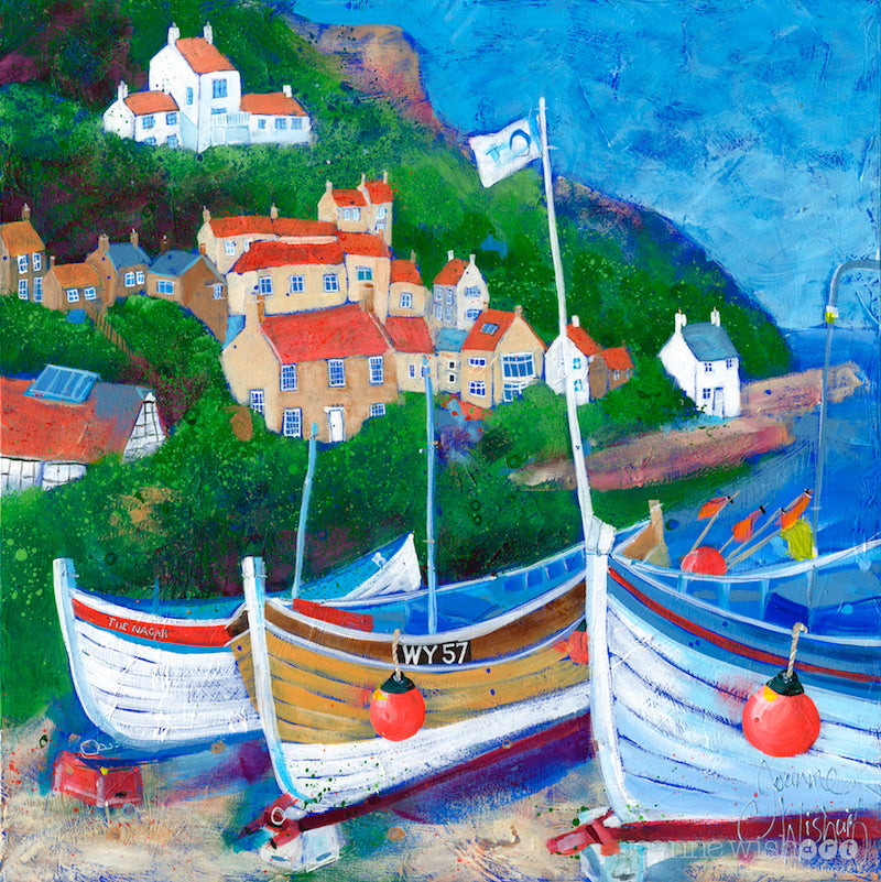 A fine art print of Runswick Bay featuring three coble boats with the village clinging on to the cliffside. 