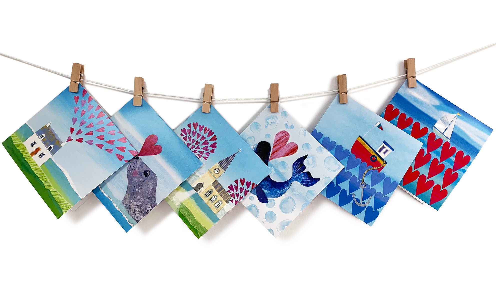 A selection of 6 love and sea themed art cards. featuring heart motifs.