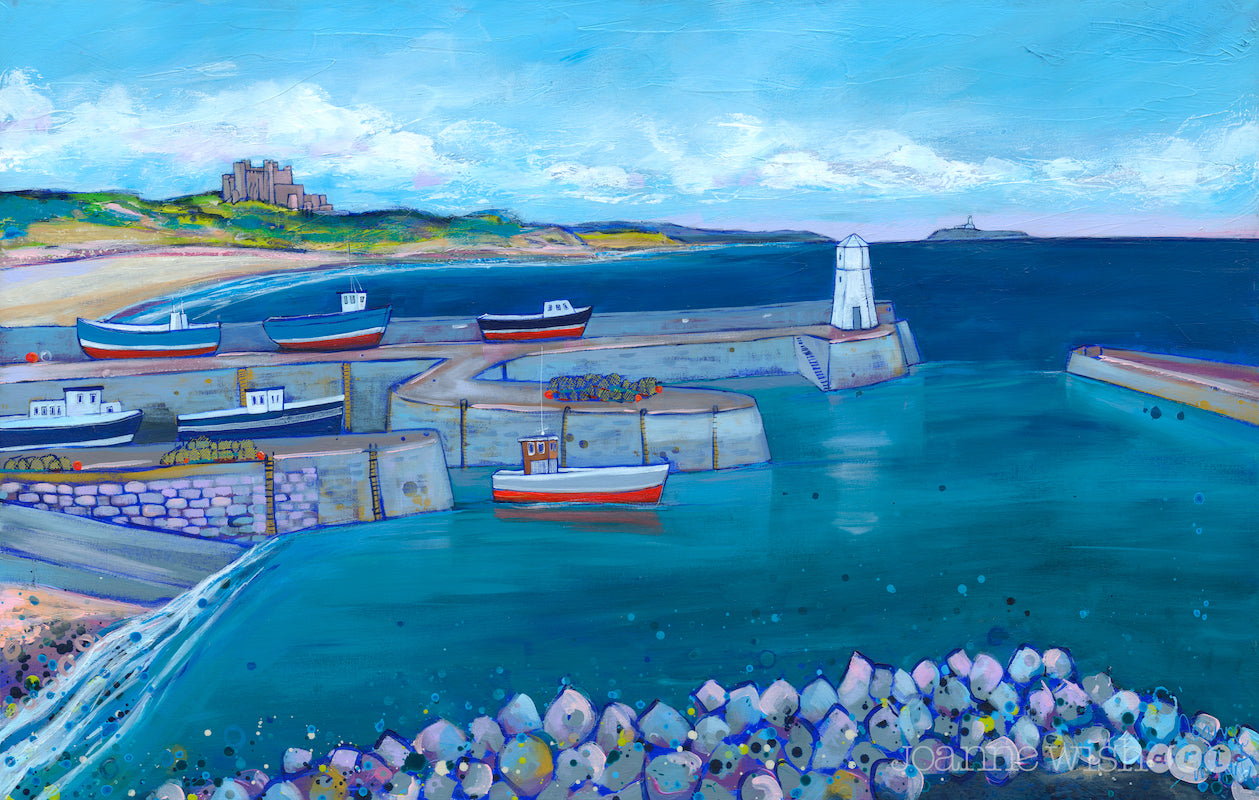 A dramatic seascape featuring seahorse harbour with colourful boats looking out towards Bamburgh Castle over the turquoise waters of the North Sea.