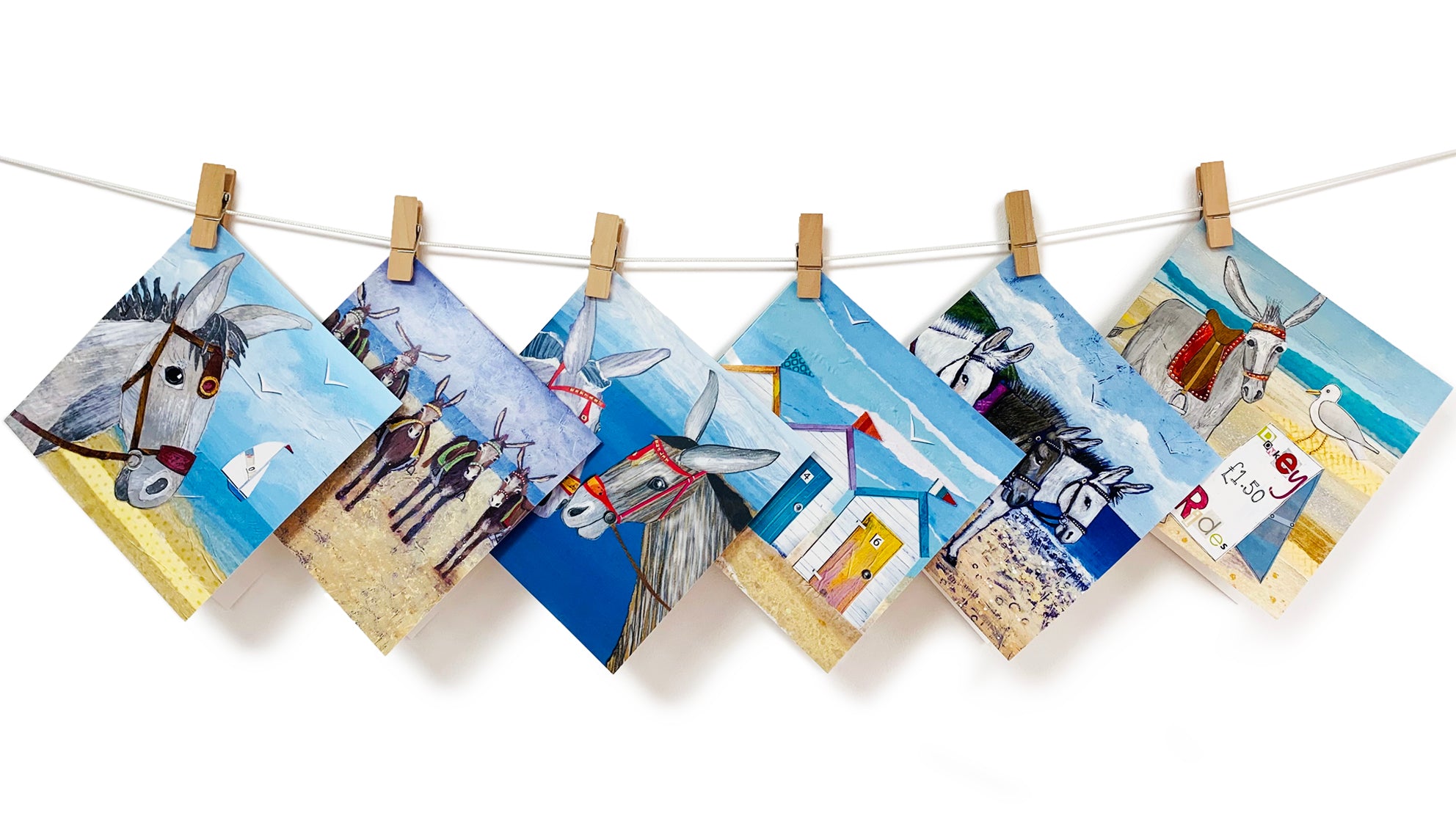 A selection of colourful greetings cards inspired by the seaside. Including Donkeys and beach huts.