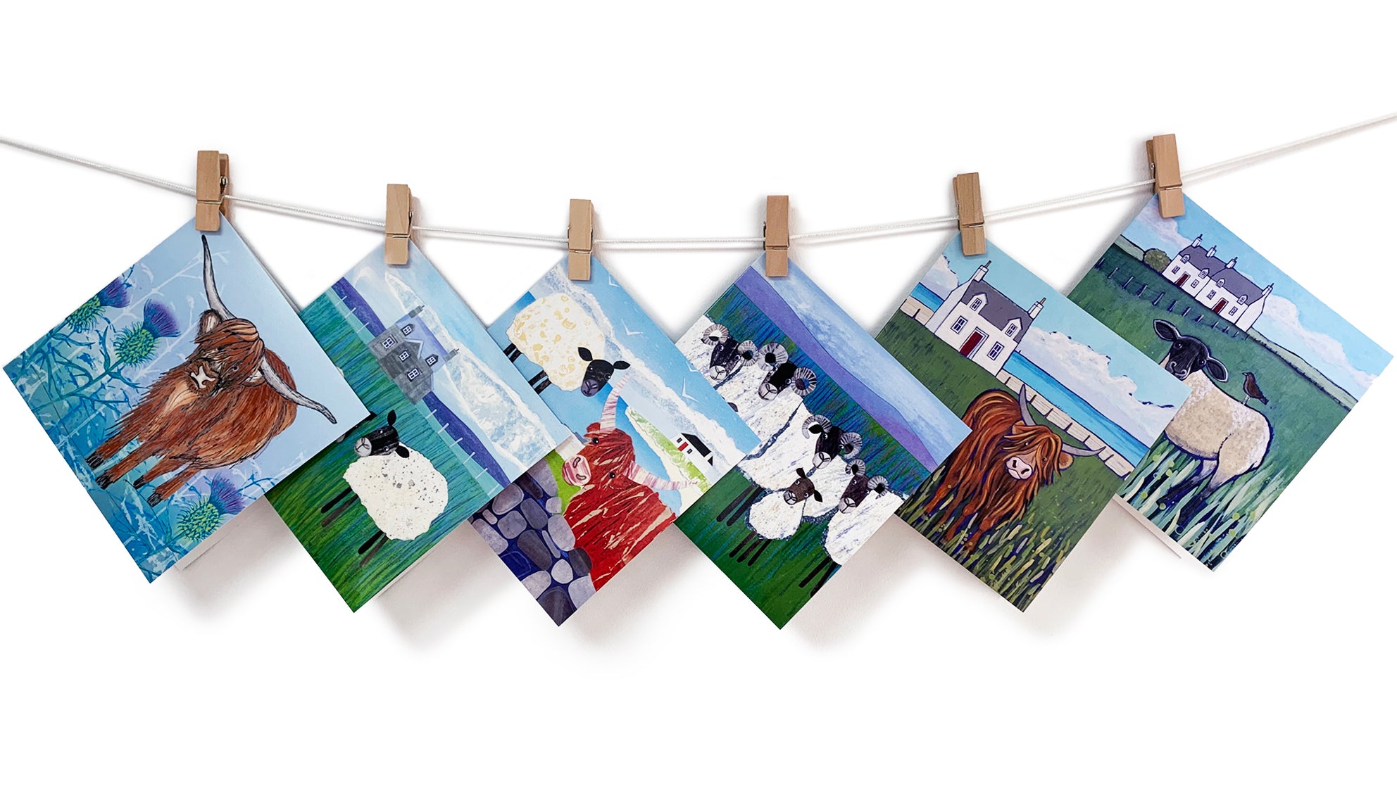 A collection of Scottish inspired art cards including sheep and highland cow designs.