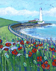 A print of St Mary's Lighthouse with a field of wildflowers in the foreground. 