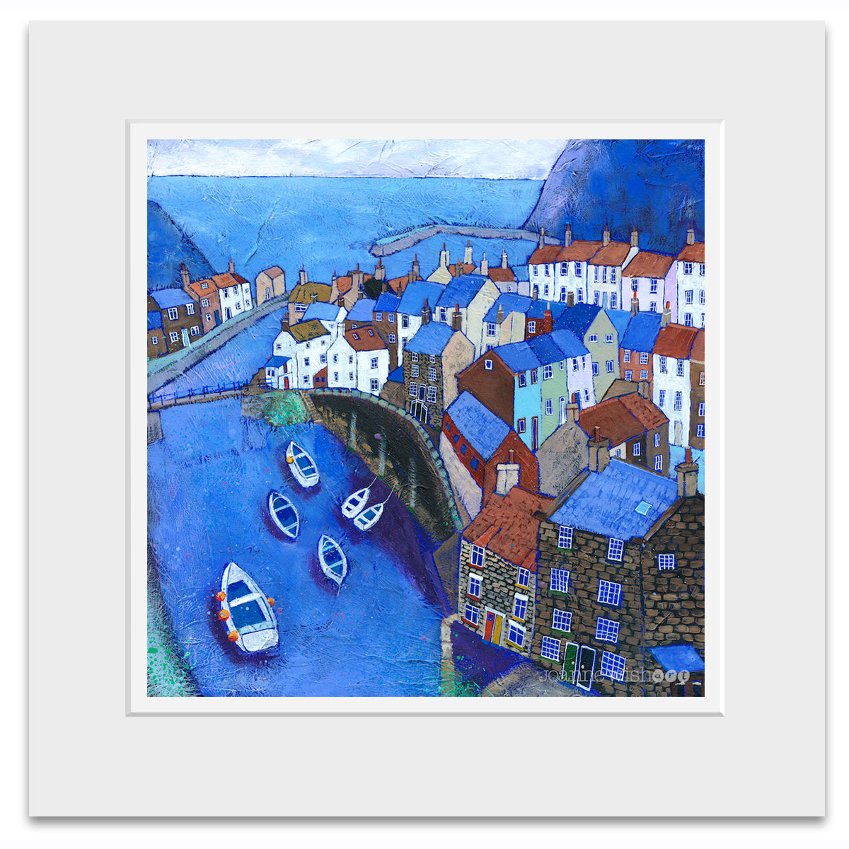 A mounted print of Staithes village. 