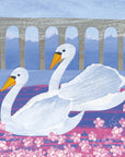 Pink bubble flowers occupy the foreground on a pink and purple toned river. A grey arched bridge can be observed in the background. The main focus of the image is two swans with an orange/yellow toned beak. They are swimming in the same direction with happy expressions. 