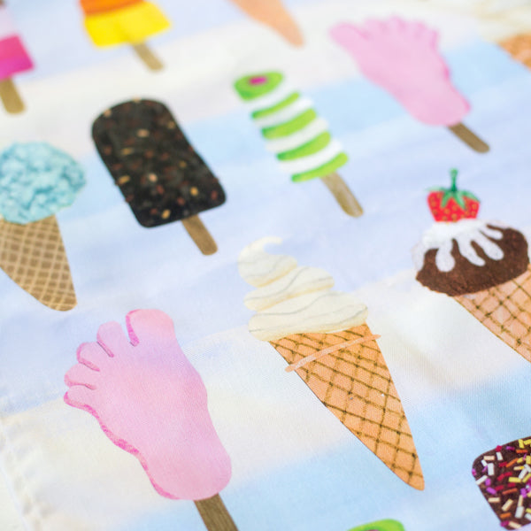 A close up of an ice cream cone on a tea towel.