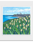 A mounted print of bright yellow daffodils with Tynemouth Priory in the distance.
