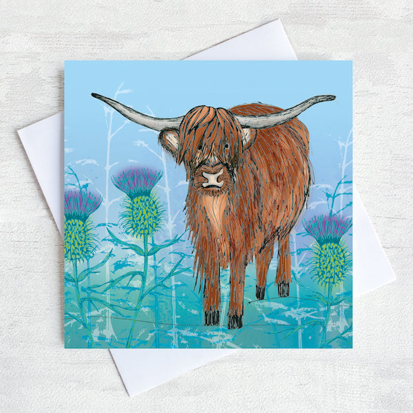 A Highland cow in the thistles on a Lavender greetings card. 